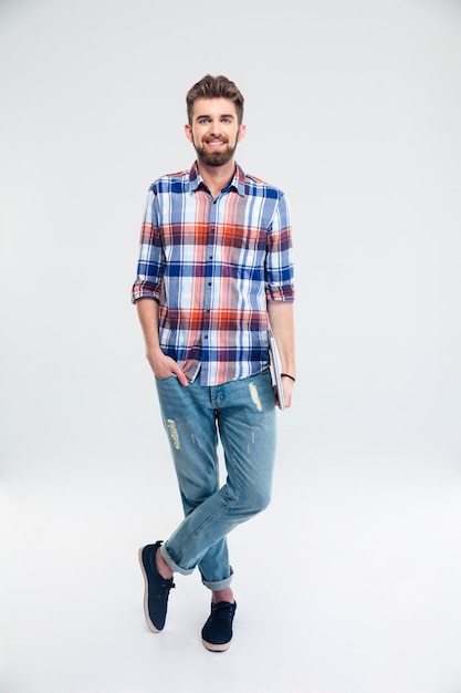 Portrait of a man standing with laptop