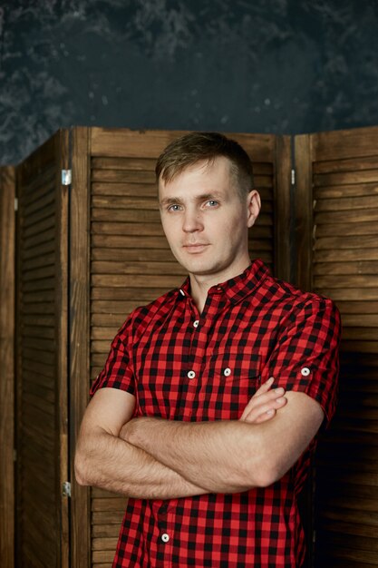 Portrait of a man in summer clothes at home