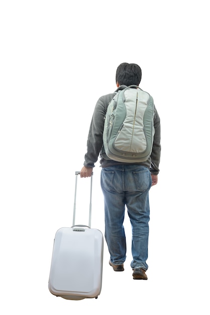 Portrait of a man traveling with suitcase and bag