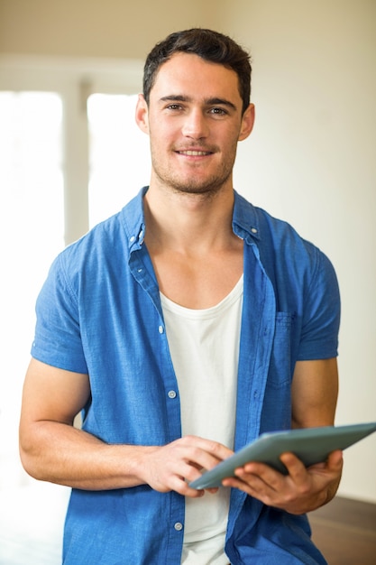 Portrait of man using digital tablet in kitchen