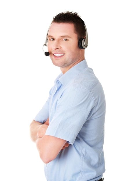 Portrait of man using headset while standing against white background