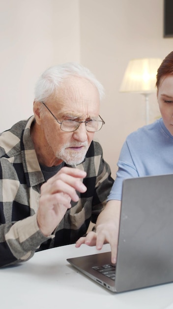 portrait of man using laptop at home
