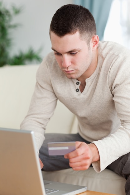 Portrait of a man using a notebook to book a flight