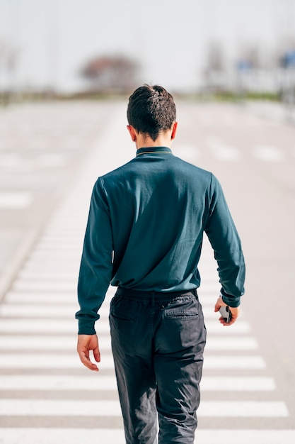 Portrait of man walking backwards