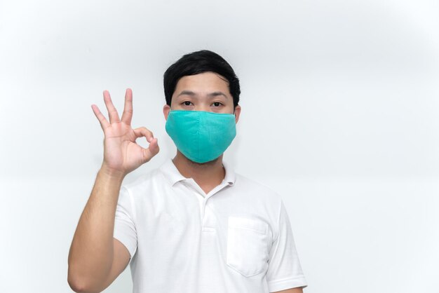 Portrait of man wear protect mask on white backgroundWearing face mask for prevent COVID19 Pandemic Coronavirusworker with medical mask for against and stop coronavirus