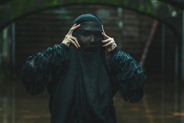 Portrait of man wearing black costume standing outdoors