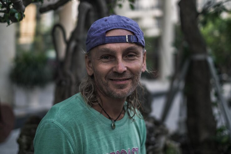 Portrait of man wearing cap while standing outdoors