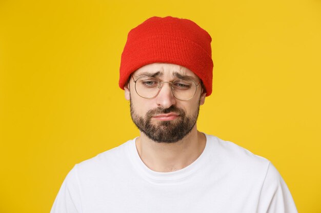 Portrait of man wearing hat against yellow background