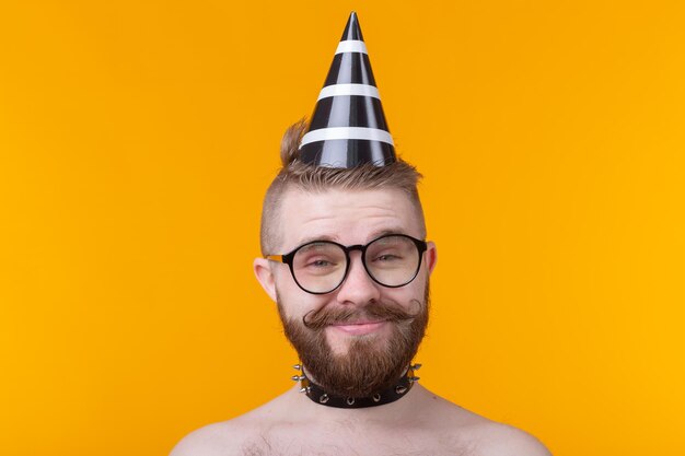 Portrait of man wearing hat against yellow background