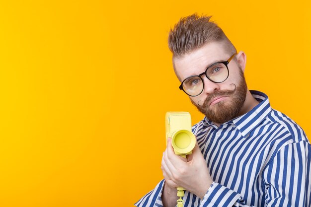 Portrait of man wearing hat against yellow background