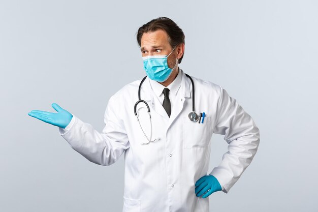 Portrait of man wearing mask against white background