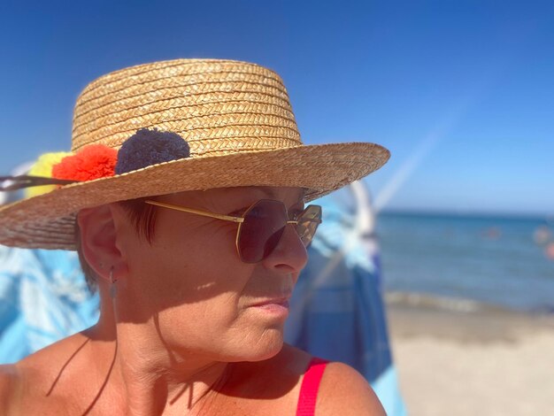 Portrait of man wearing sunglasses at beach against sky