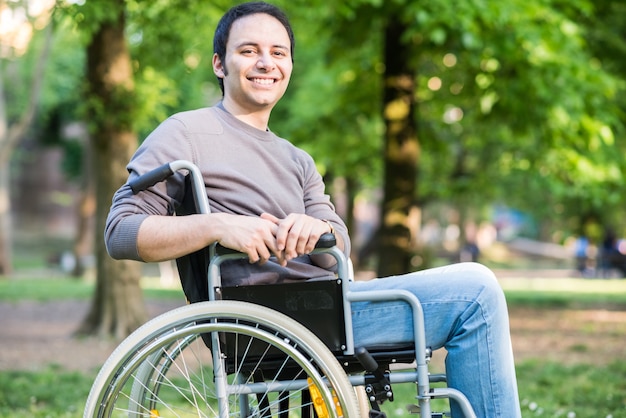 Portrait of a man on a wheelchair in a park