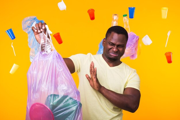 Portrait of man with arms raised against blue background