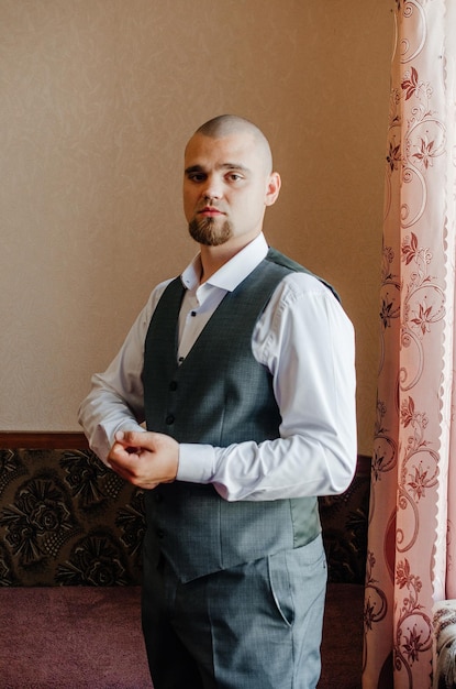 portrait of a man with a beard in a white shirt and gray vest