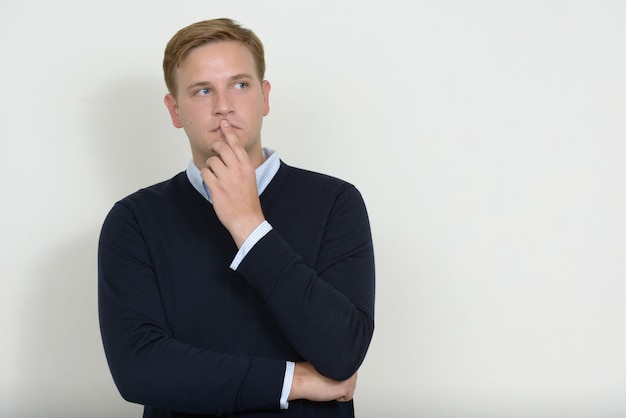 Portrait of man with blond hair thinking and looking up