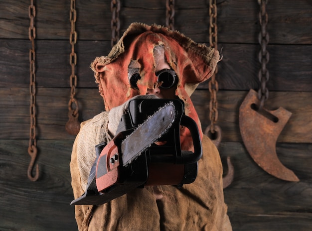 Photo portrait man with burlap on his face black background horrors and halloween