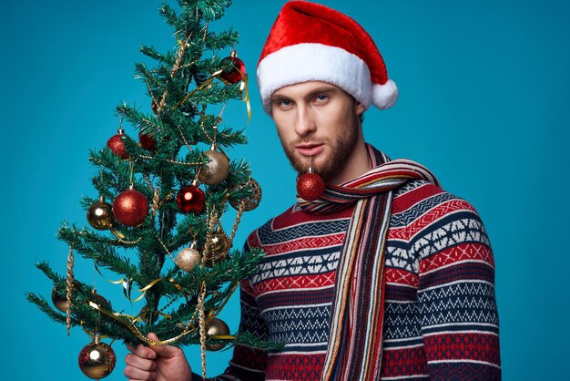 Portrait of man with christmas tree in winter