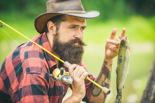 Portrait of man with fishing rod fisherman men in river water outdoor summer fishing hobby