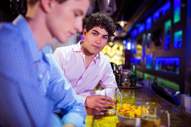 Portrait of man with friend enjoying drink