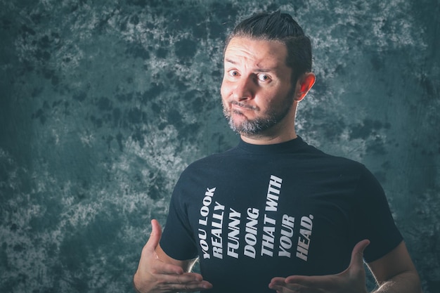 Portrait of man with funny text on his shirt