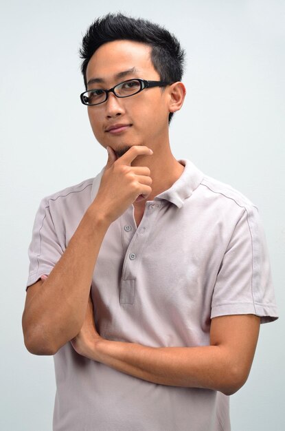 Portrait of man with hand on chin against white background