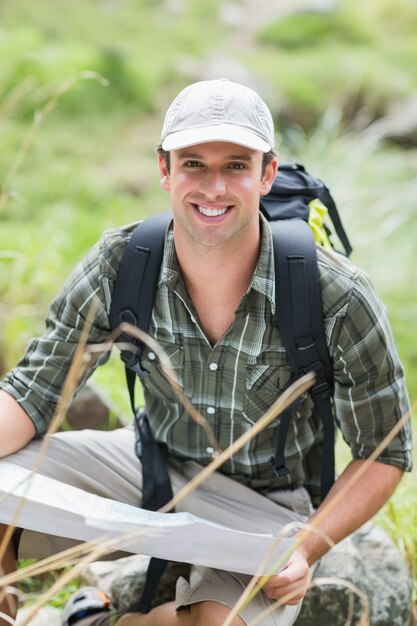 Portrait of man with map in forest