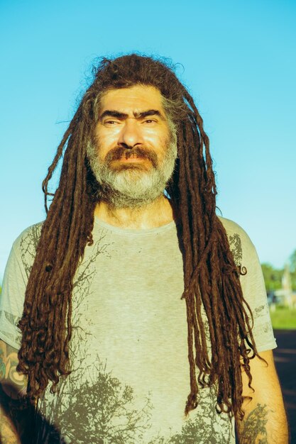 Portrait of man with rastas or dreadlocks