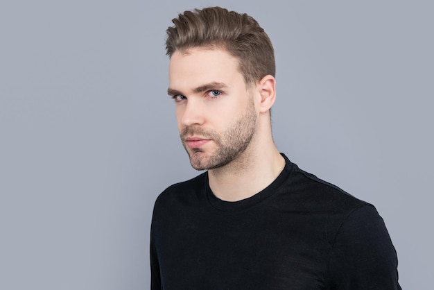 Portrait of man with stubble in studio man with stubble isolated on grey background