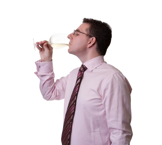 Portrait of a man with tie tasting a glass of white wine