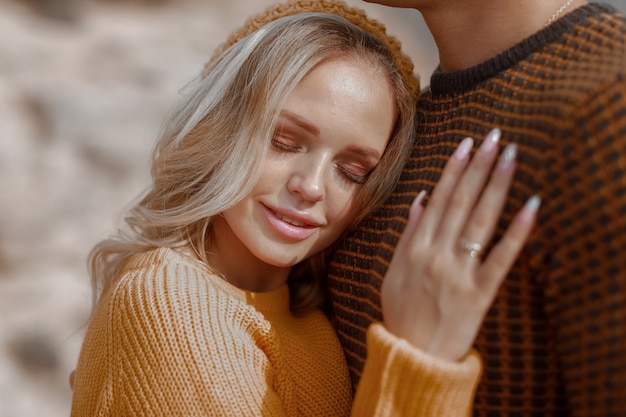 Portrait of a man with a woman in yellow warm sweaters