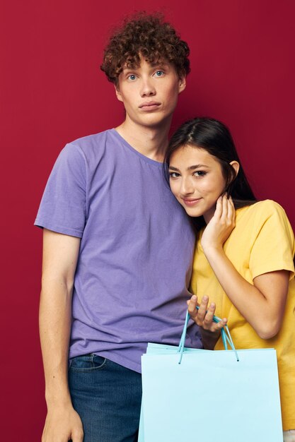 Portrait of a man and a woman colorful bags shopping fun isolated background unaltered