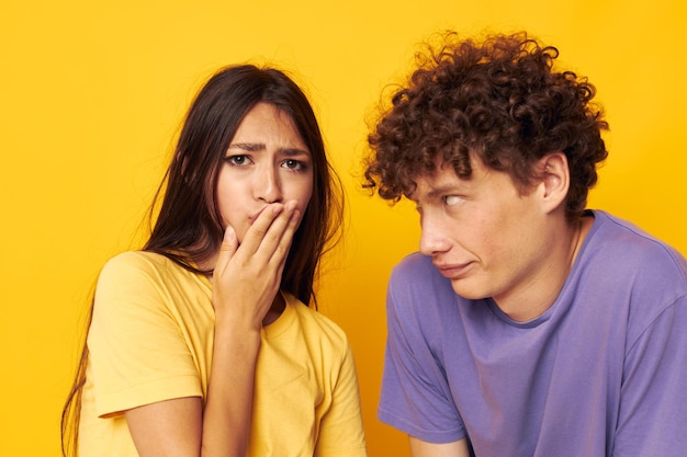 Portrait of a man and a woman in colorful tshirts posing friendship fun isolated background unaltered