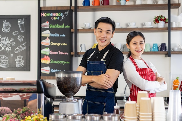 Portrait of man and woman waitress  standing at coffee shop