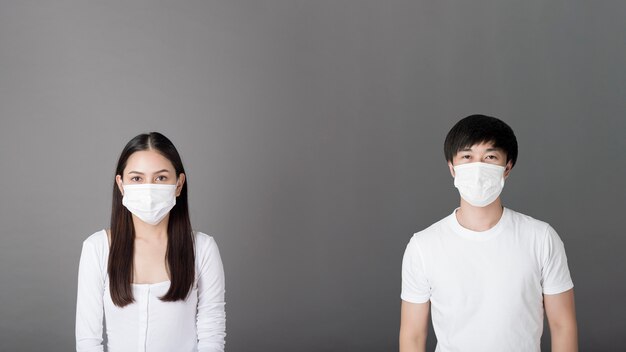 Portrait of man and woman with surgical mask, social distancing  concept