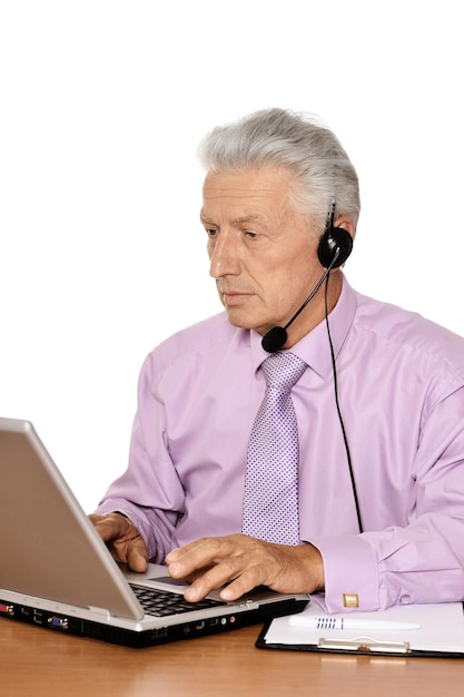 Portrait of a man working on laptop, in office