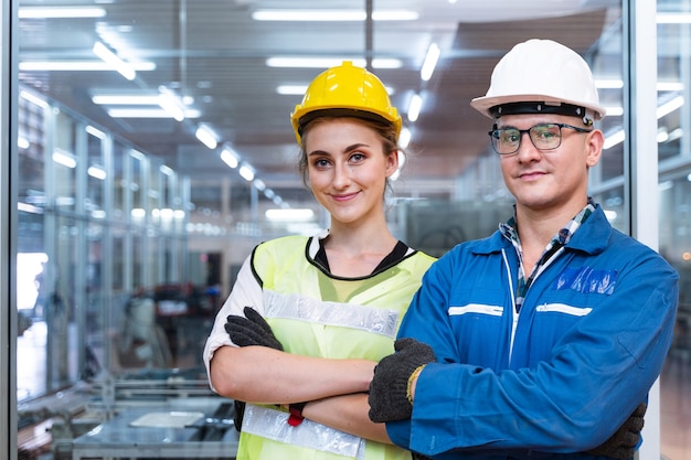 Portrait of manual man and woman worker is standing with confident with blue working suite