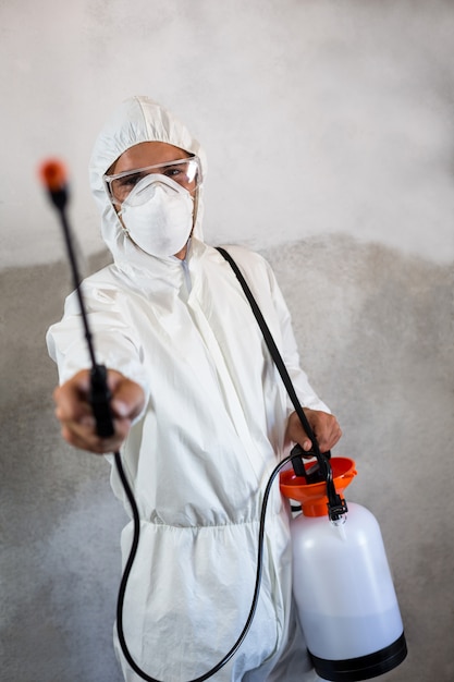 Portrait of manual worker holding crop spray