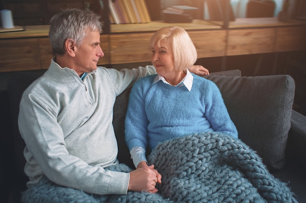 Portrait of married couple sitting on the couch