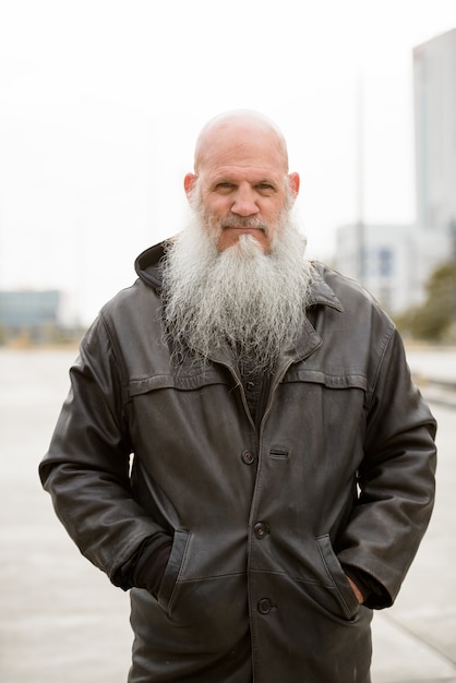portrait of mature bald hipster man with long beard