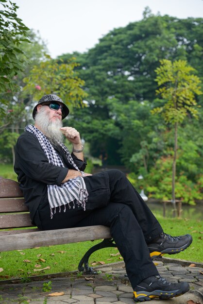 Портрет зрелого бородатого хипстера в парке на открытом воздухе