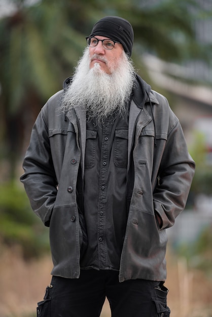 portrait of mature bearded hipster man with eyeglasses thinking