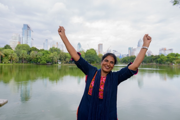 Portrait of mature beautiful Indian woman exploring the city of Bangkok, Thailand