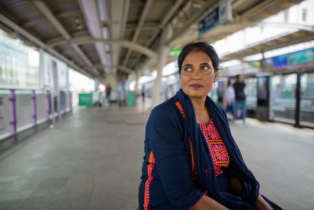 Portrait of mature beautiful Indian woman exploring the city of Bangkok, Thailand