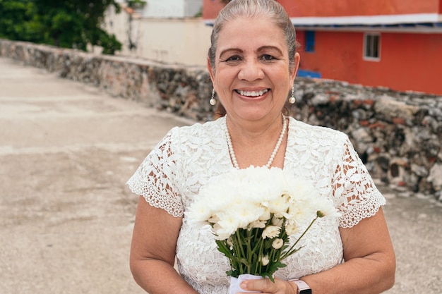 Portrait of mature bride holding the bouquet