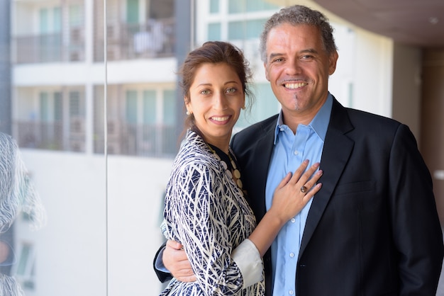 Portrait of mature businessman and beautiful businesswoman together