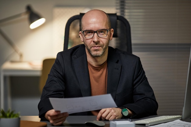 Portrait of Mature Businessman Working at Night