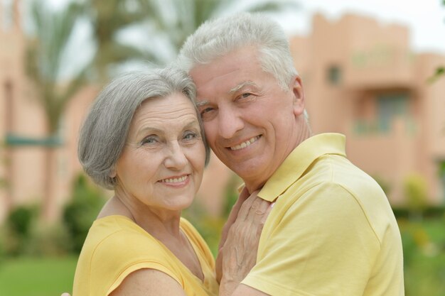 Portrait of a mature couple near wall on street