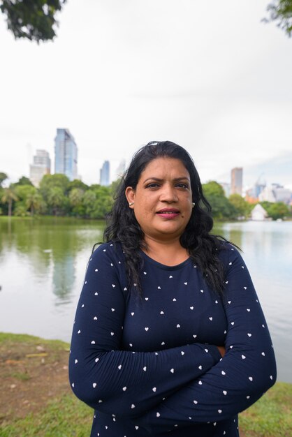 Portrait of mature Indian woman relaxing at the park