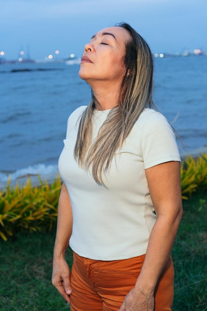 Portrait of mature Latina woman pensive in park